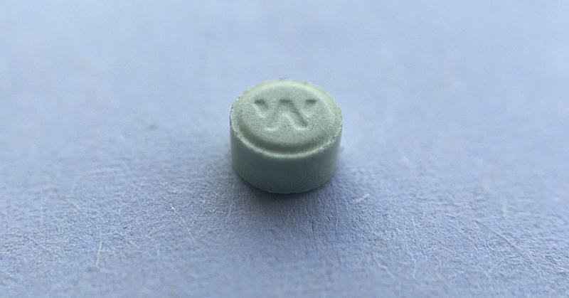 Extreme closeup photograph of an Ativan pill.